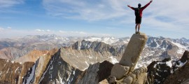 man-standing-on-edge-of-cliff