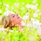 Close-up of a beautiful young woman among dandelions.