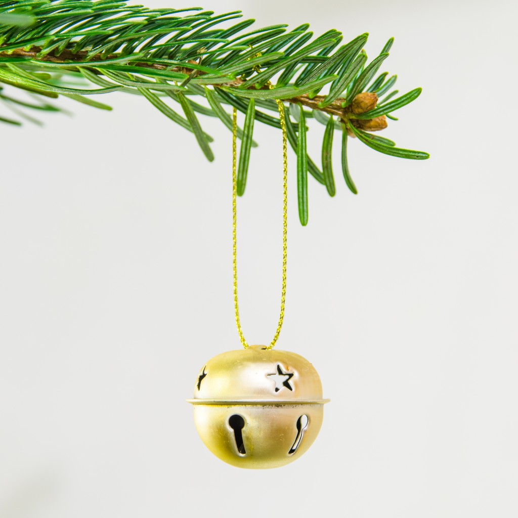 Decorative jingle bell ornament in a Christmas tree