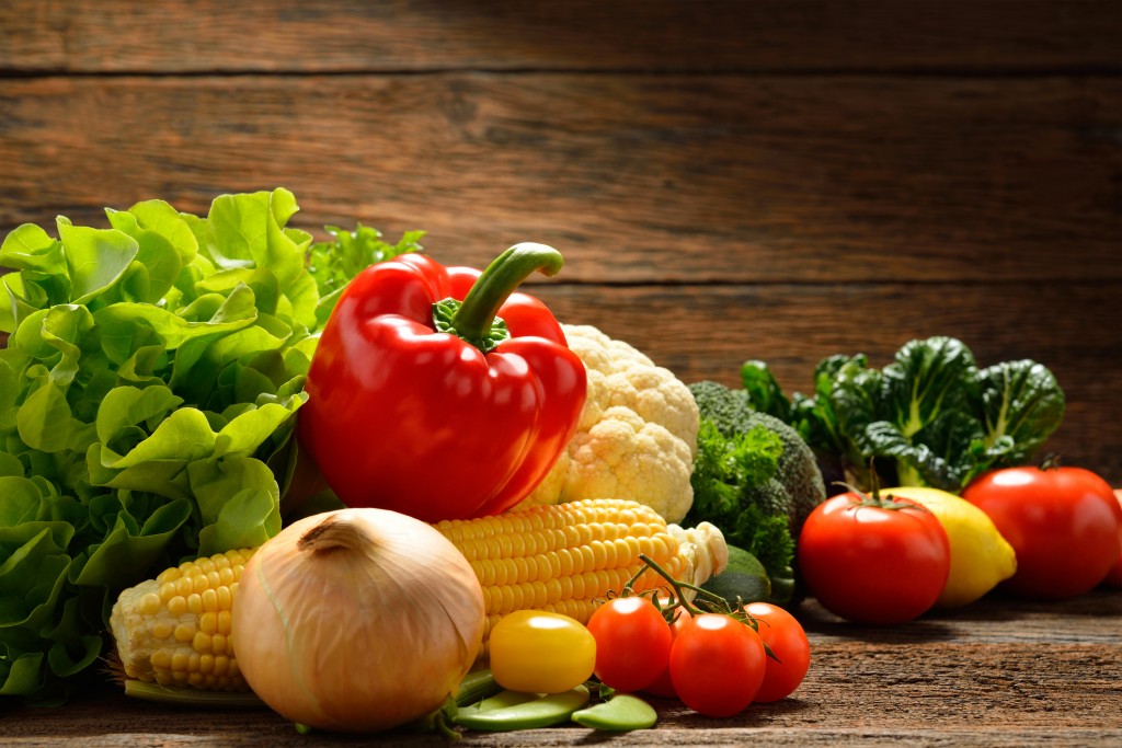 Vegetables isolated on wooden background
