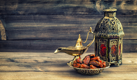 Ramadan lamp and dates on wooden background. Oriental lantern